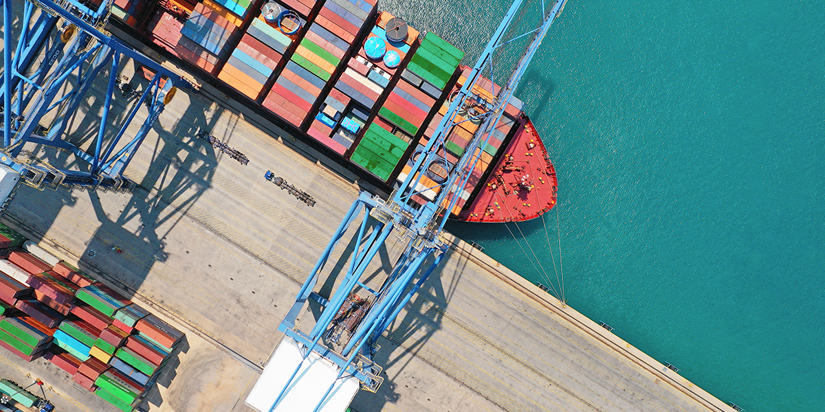 arial view of a ship with many containers in a port