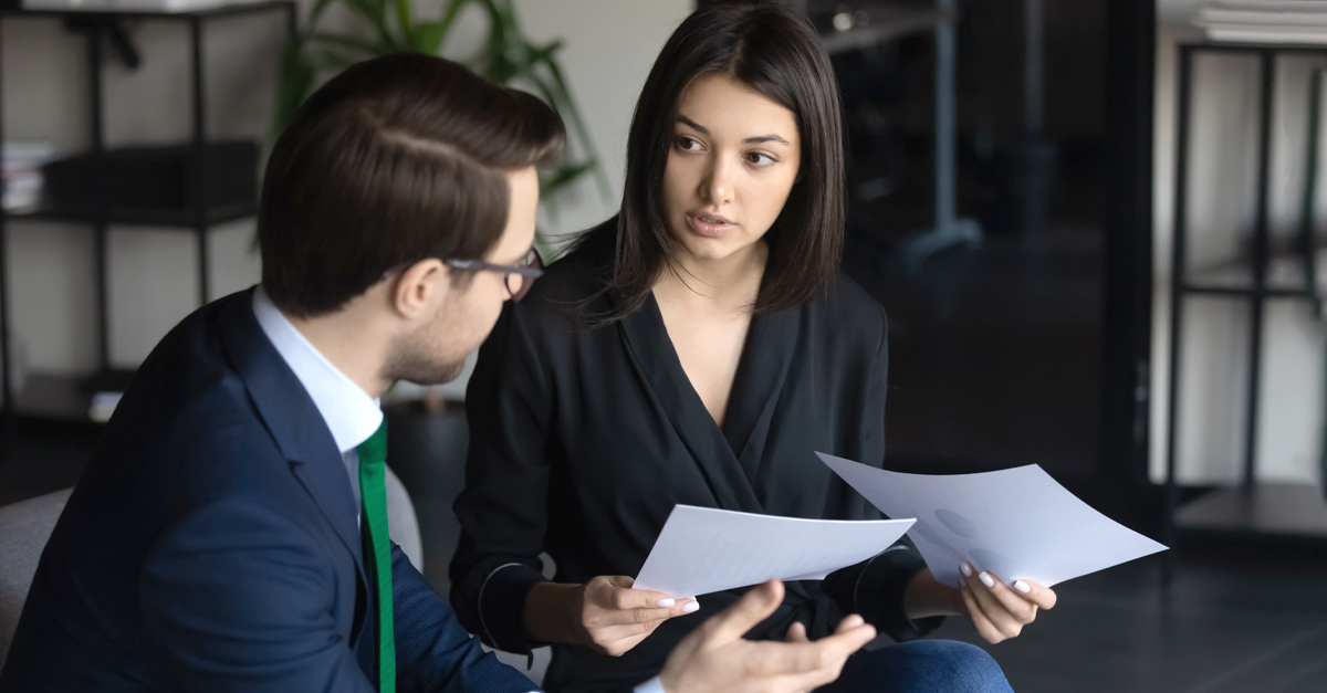 man and woman discussing paperwork