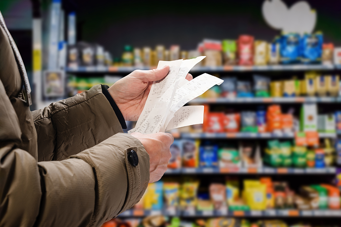A shopper looks at his grocery receipts. Consumer expectations may affect inflation trends.